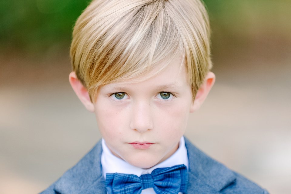 Close portrait of a boy in a blue bow tie and jacket