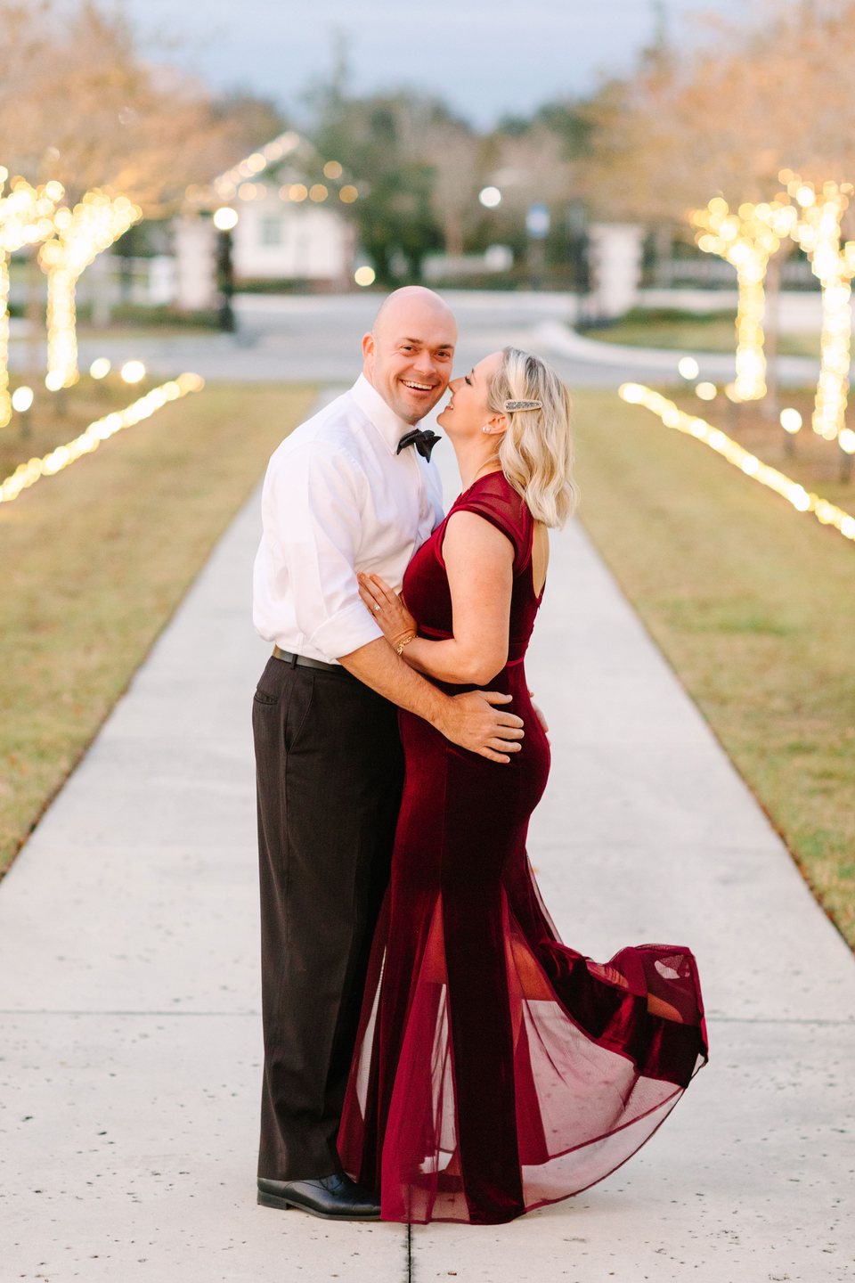 Couple in formal dress on a tree-lined path