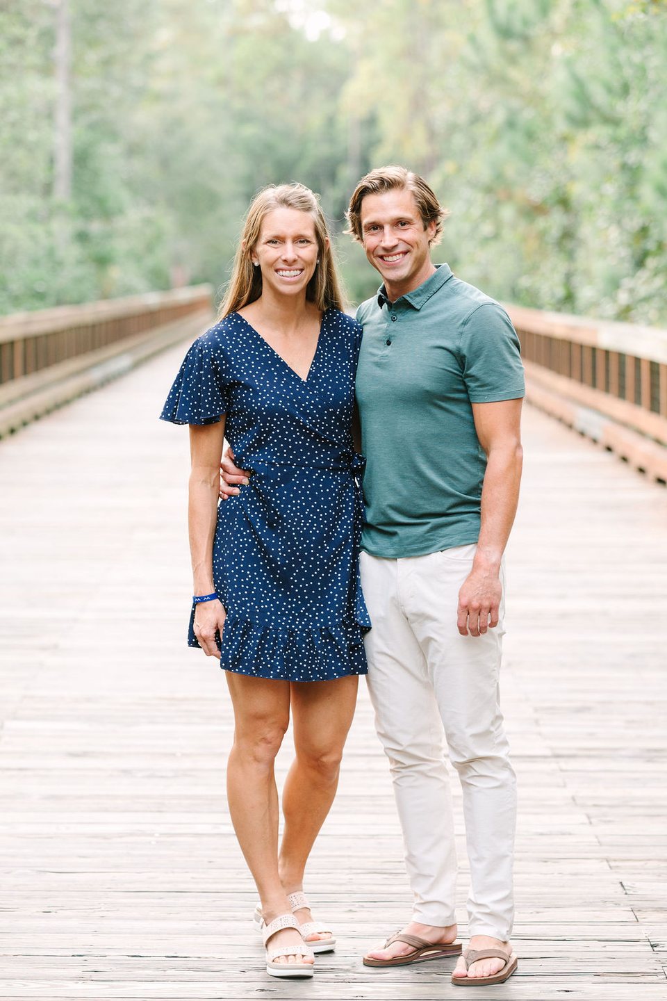 Couple standing together on a wooden boardwalk