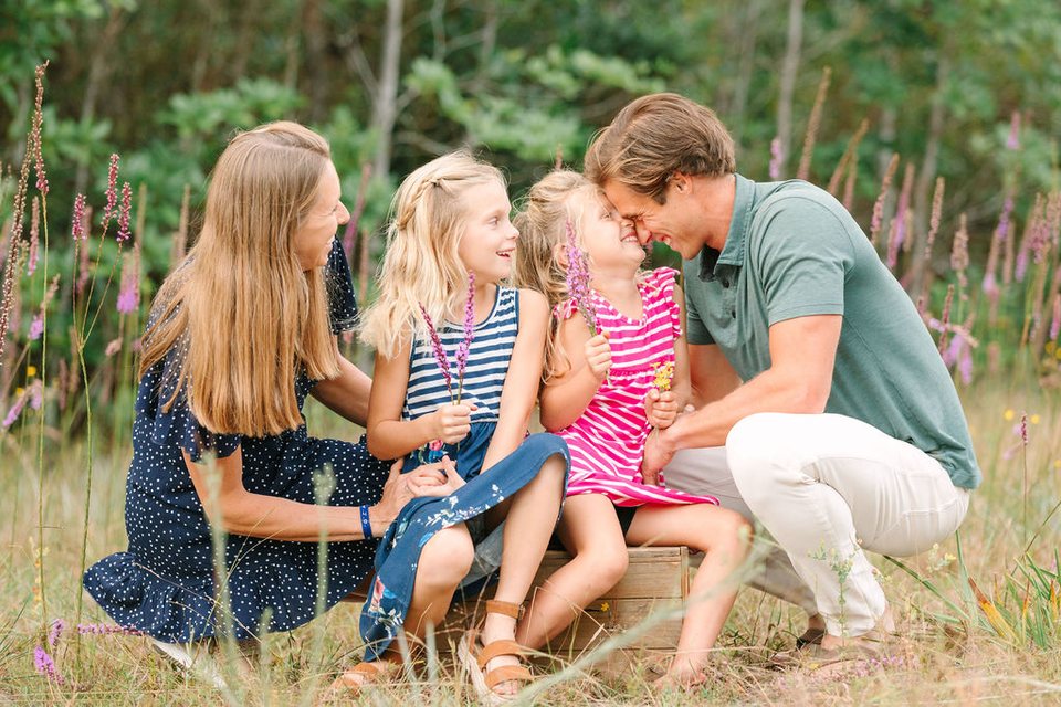Family playing together among wildflowers